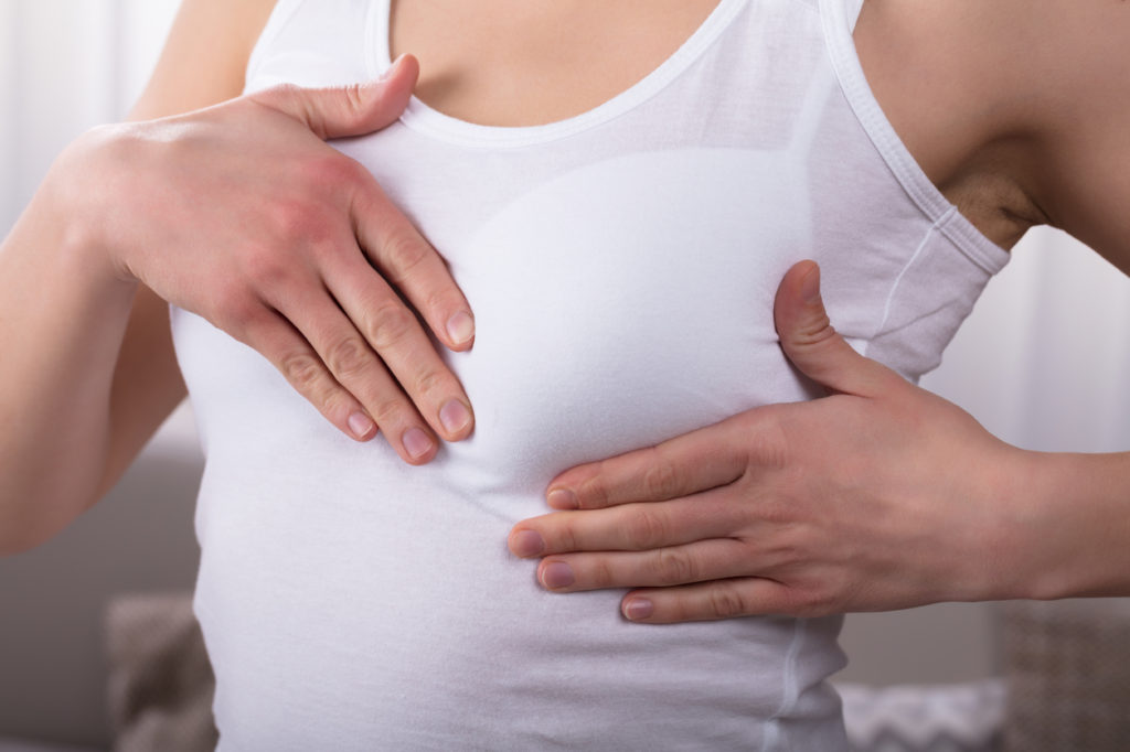 Close-up Of A Woman's Hand On Breast